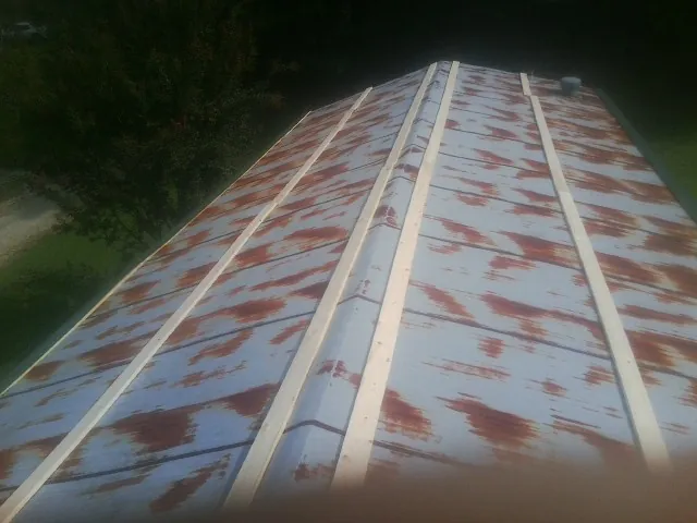 Rusted metal roof panels with new wood purlins before replacement — Storm Damage Roof Repair in Minier by Roofing Brothers